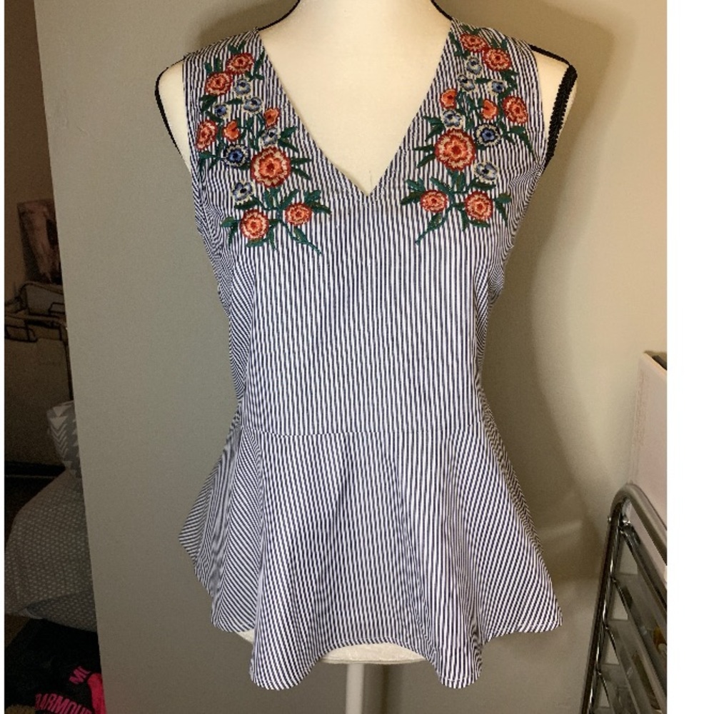 Striped peplum top with embroidered flowers